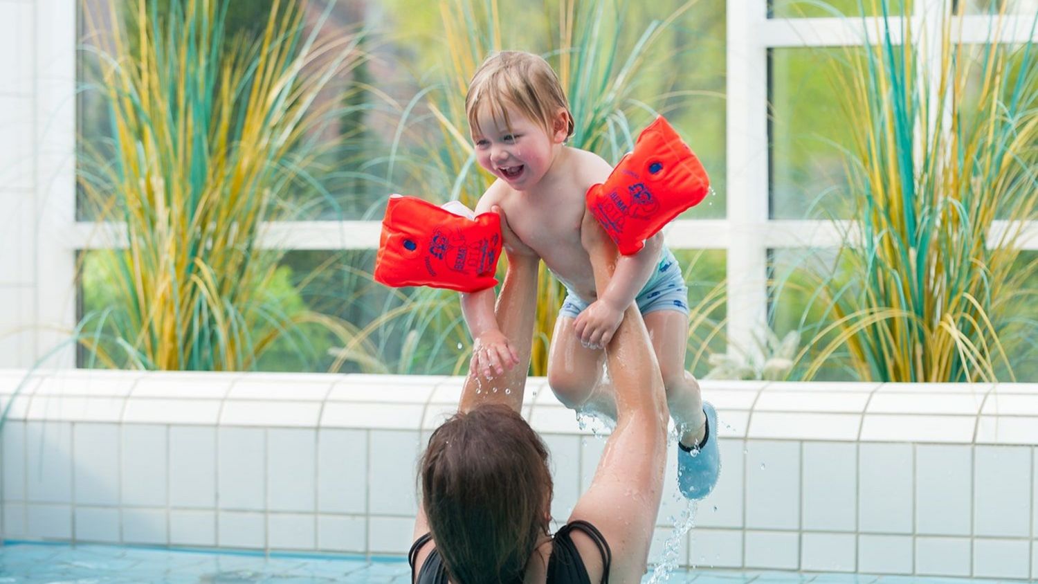 Spaßbecken · Mama wirft Kind in die Luft